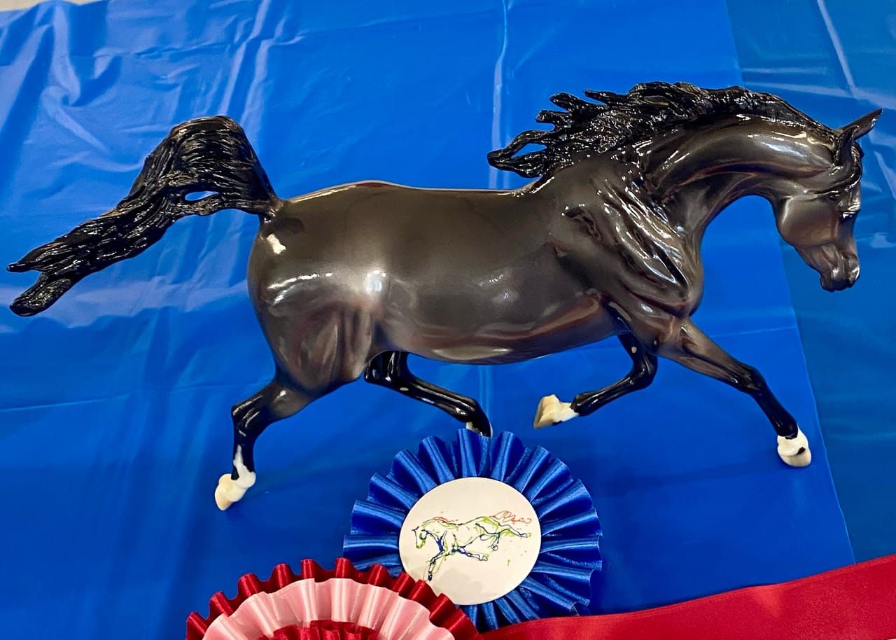 Model horse with show ribbons